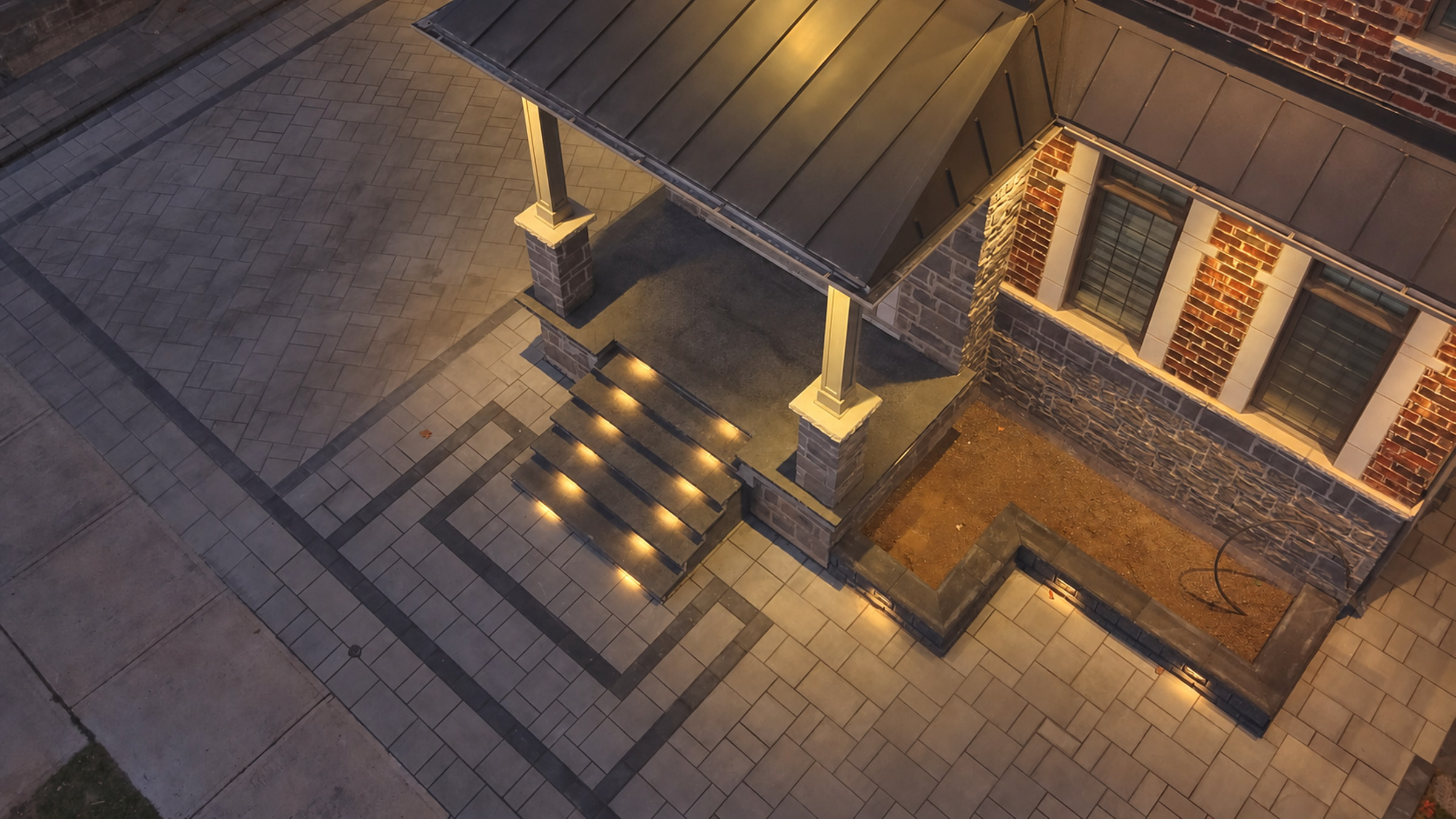 Completed interlocking front entrance with evenly illuminated steps and coordinated stone borders